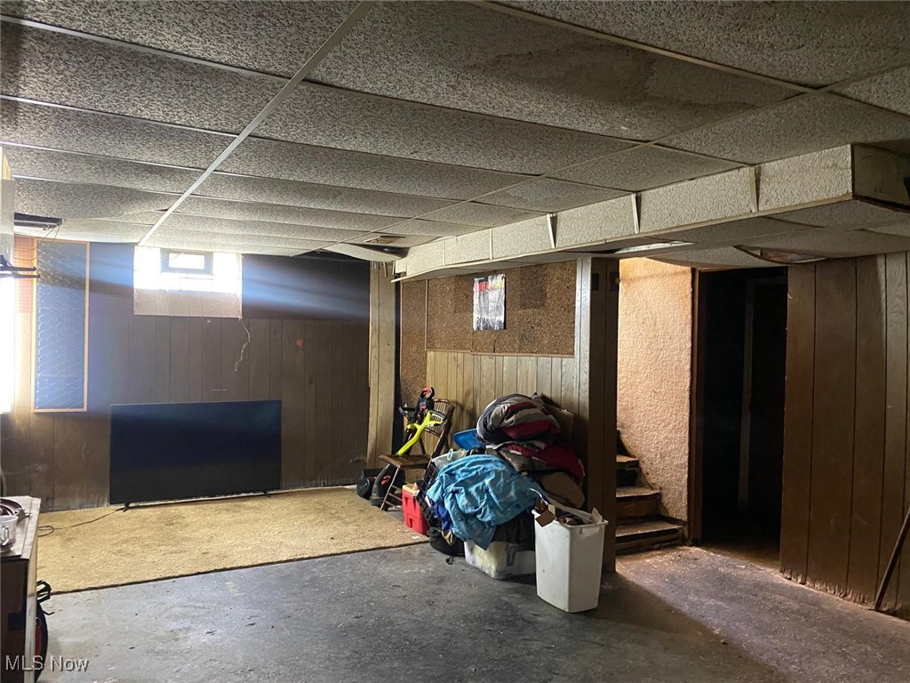 17011 Ridgeton Drive Cleveland, OH 44128 - Photo 25 of 35 Basement with wooden walls and a paneled ceiling