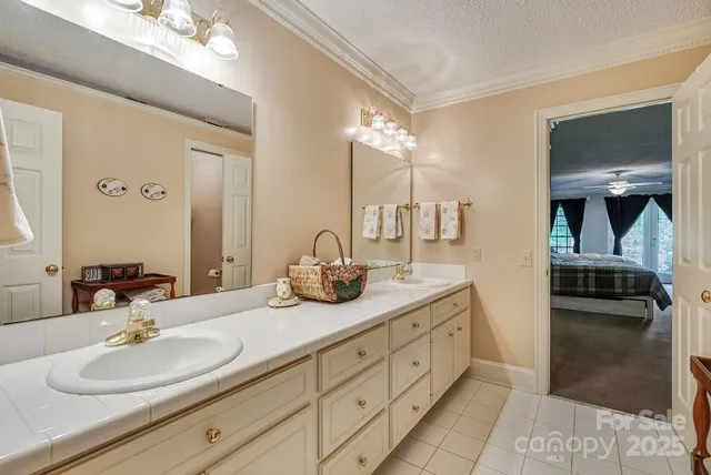 a en suite bathroom with double sink and a mirror