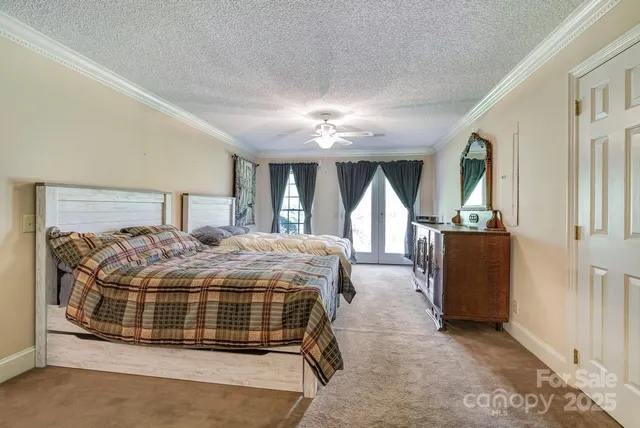 a bedroom with a large bed and a chandelier