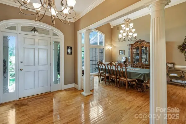 a view of a dining room with furniture and chandelier