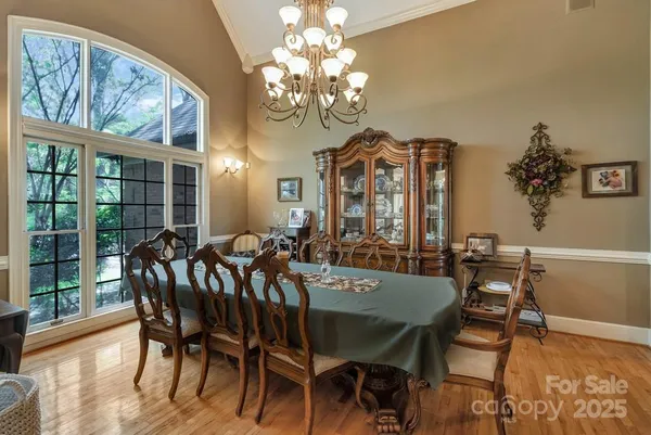 a view of a dining room with furniture wooden floor and chandelier