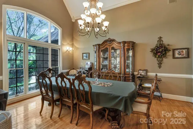 a view of a dining room with furniture wooden floor and chandelier