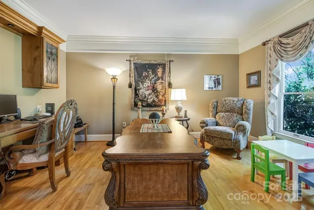 a dining room with furniture and wooden floor