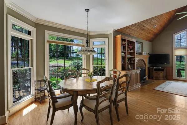 a dining room with furniture window and wooden floor