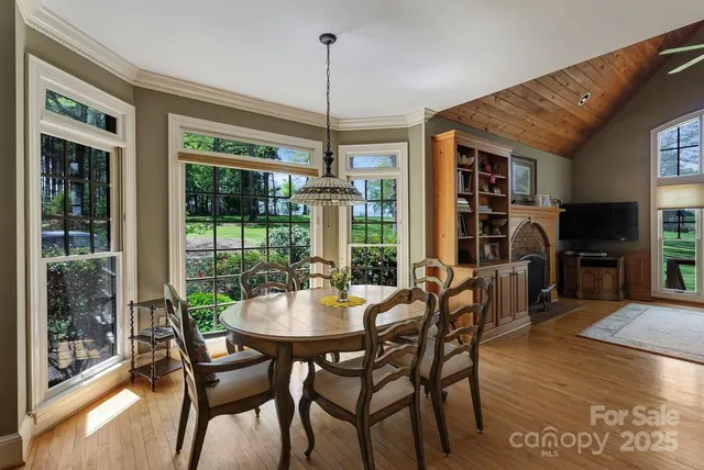 a dining room with furniture window and wooden floor
