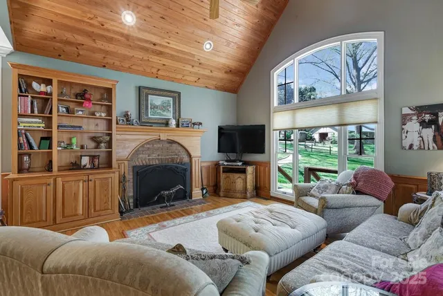 a living room with furniture a fireplace and a flat screen tv