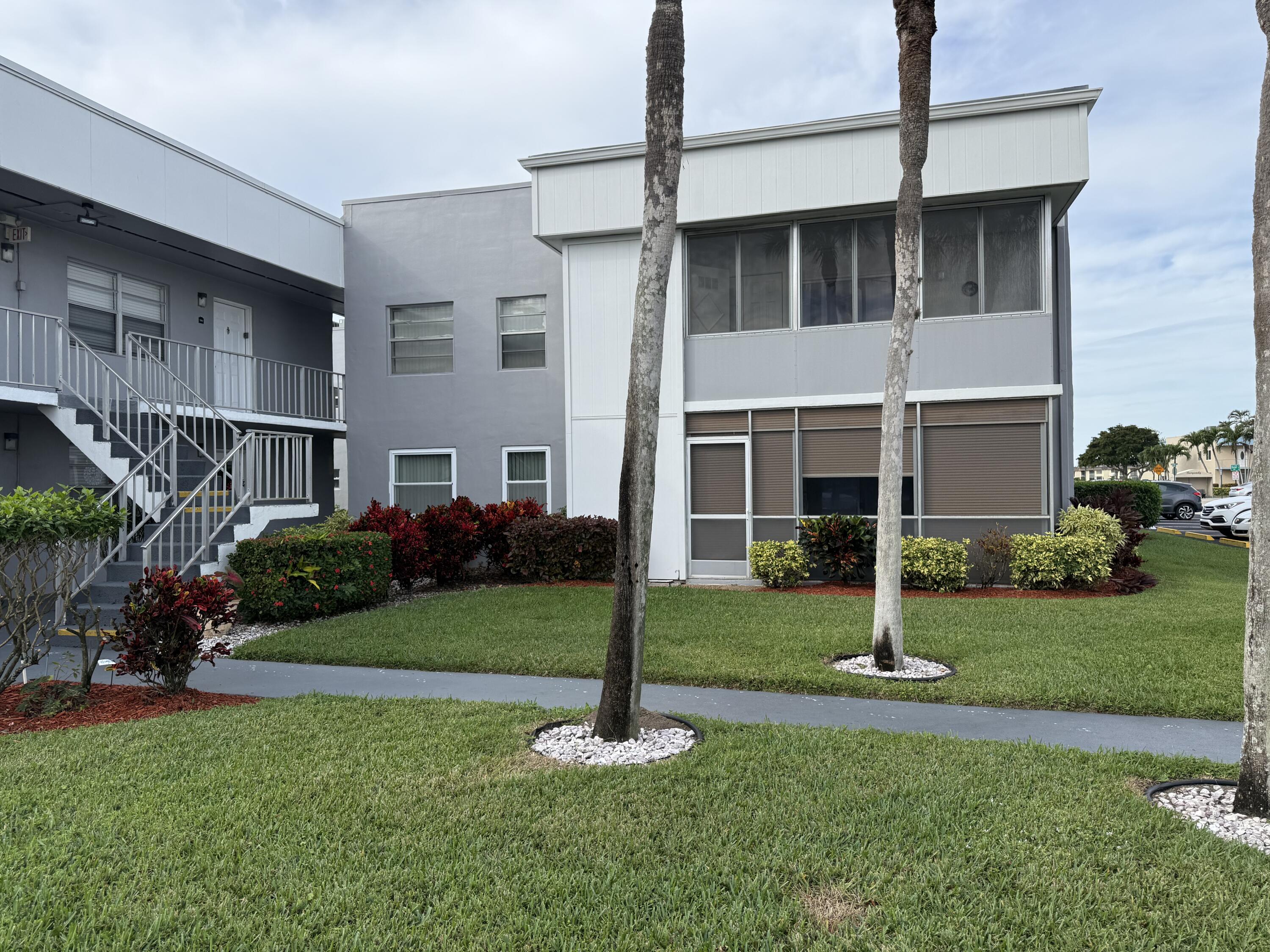 147 Burgandy Way Delray Beach, FL 33484 - Photo 1 of 14 a front view of a house with a yard