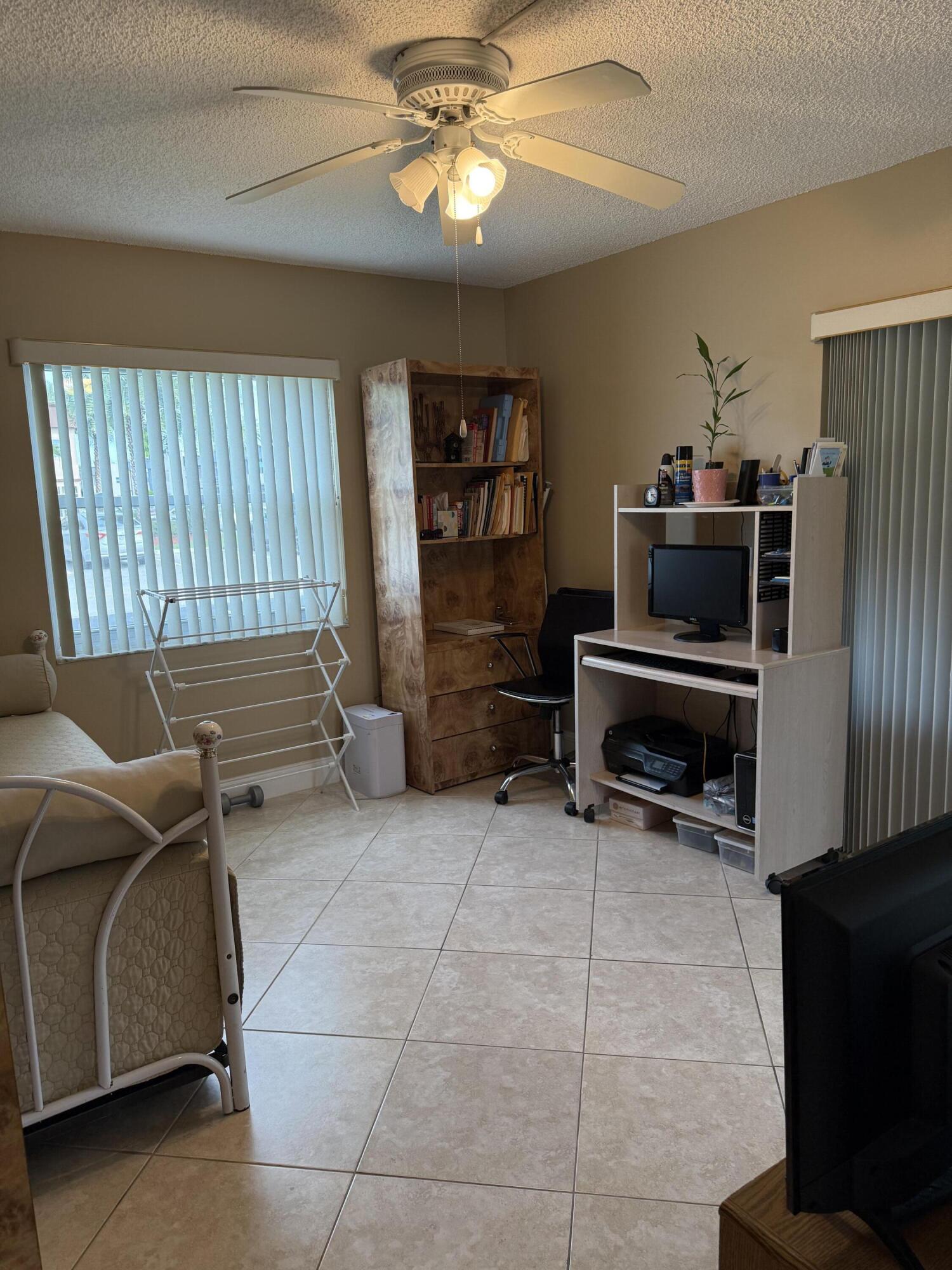 147 Burgandy Way Delray Beach, FL 33484 - Photo 12 of 14 a living room with furniture a piano and a flat screen tv