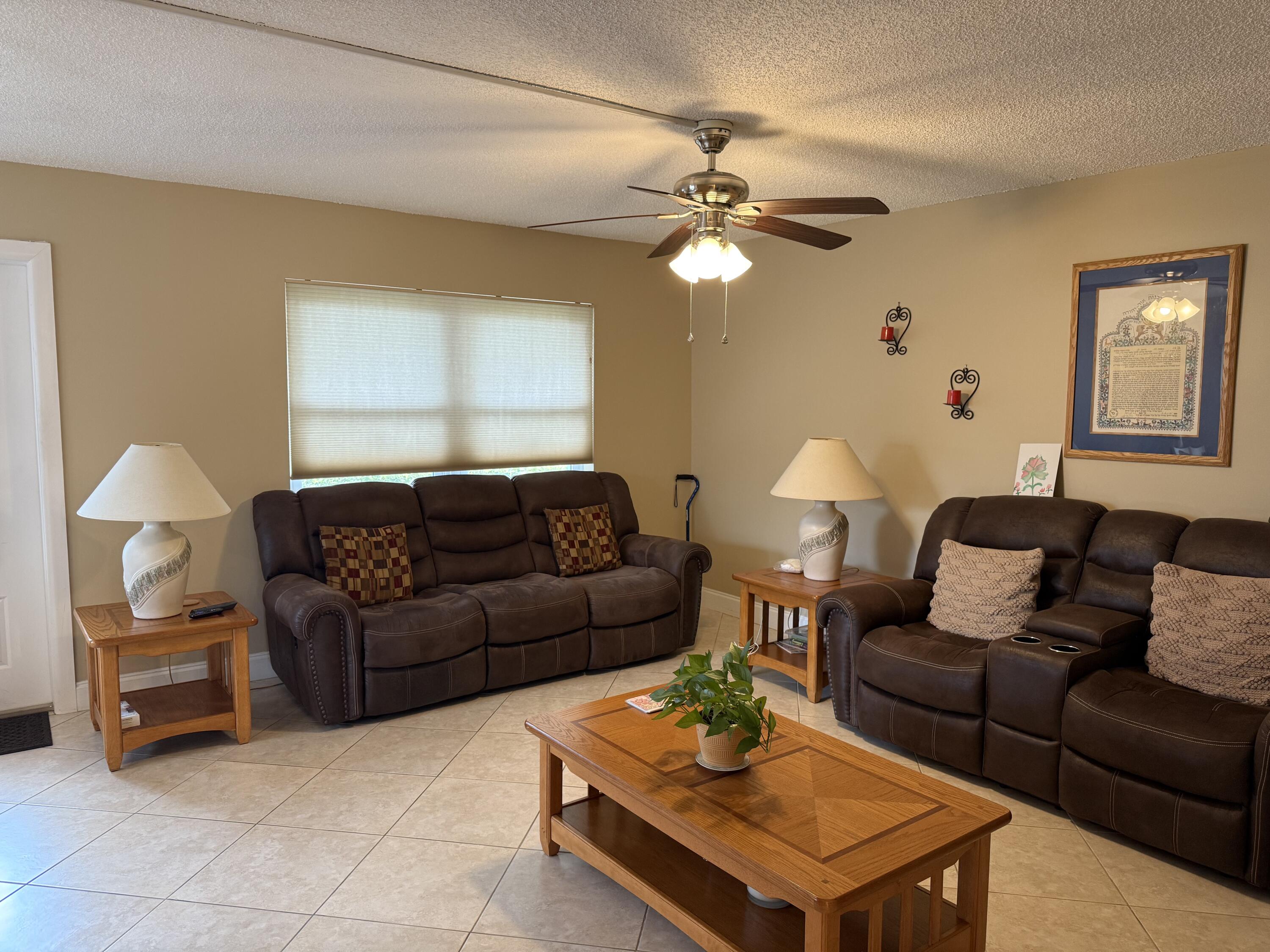 147 Burgandy Way Delray Beach, FL 33484 - Photo 3 of 14 a living room with furniture and a lamp