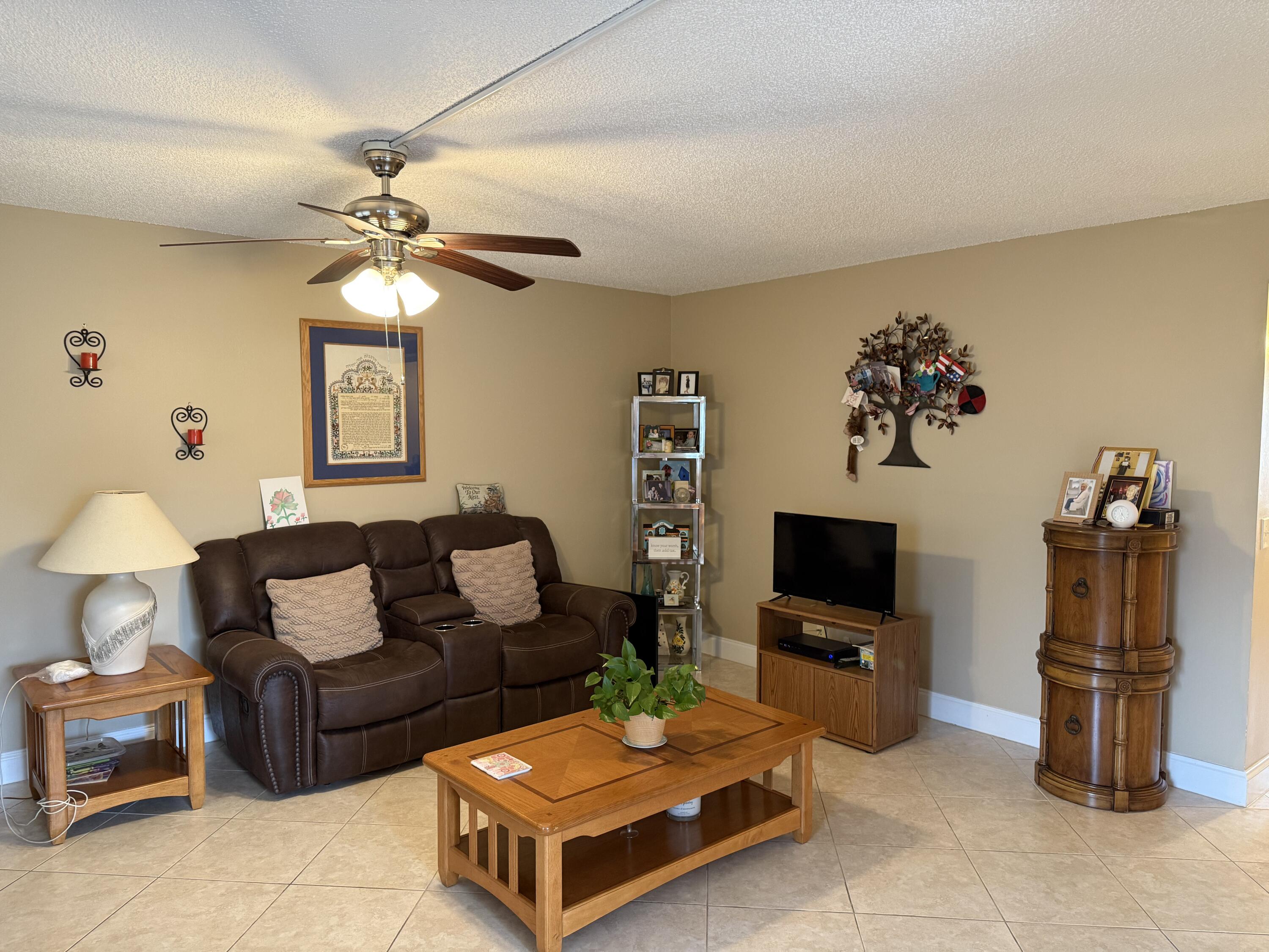 147 Burgandy Way Delray Beach, FL 33484 - Photo 4 of 14 a living room with furniture and a flat screen tv
