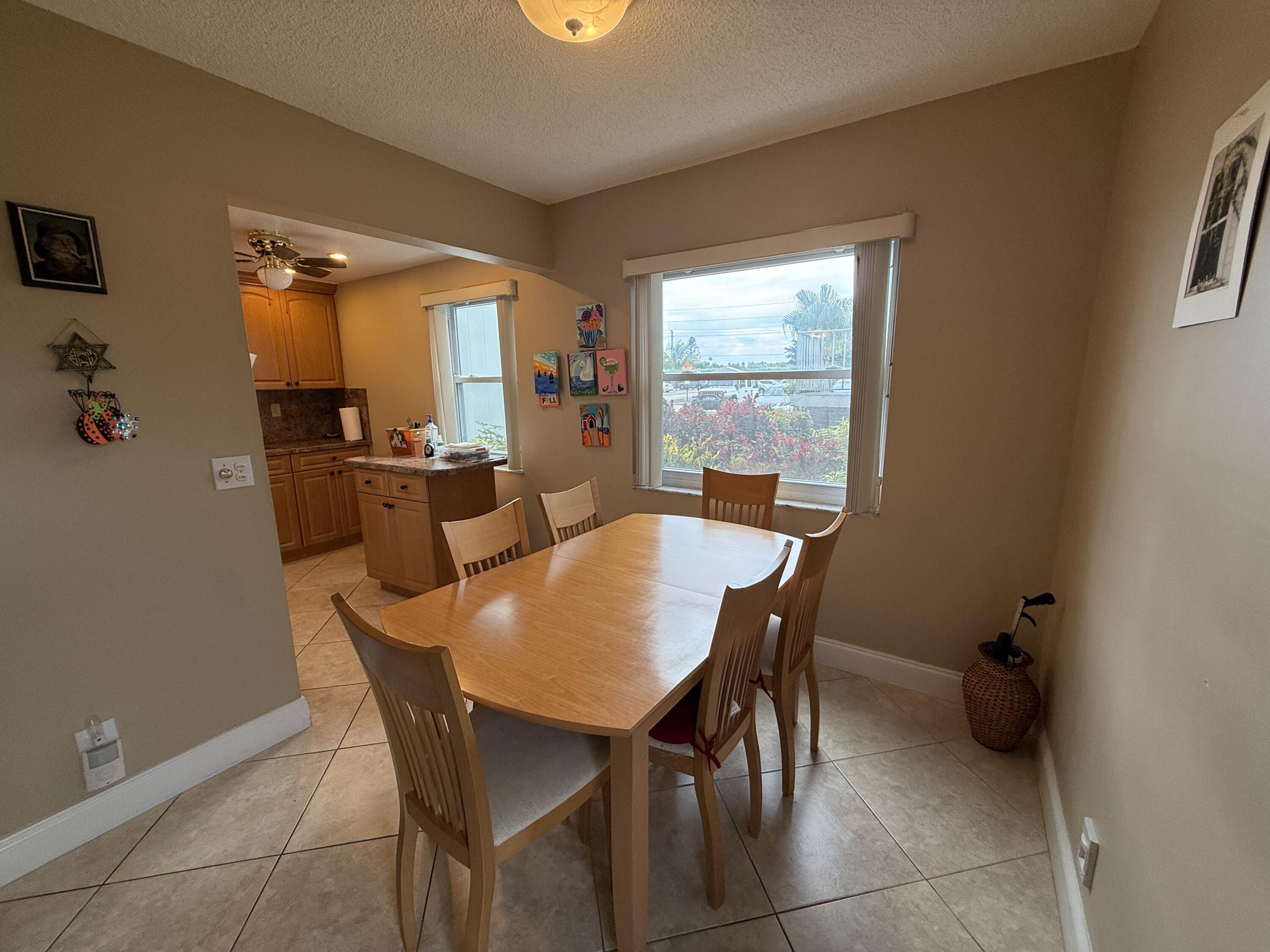147 Burgandy Way Delray Beach, FL 33484 - Photo 5 of 14 a view of a dining room with furniture and a window