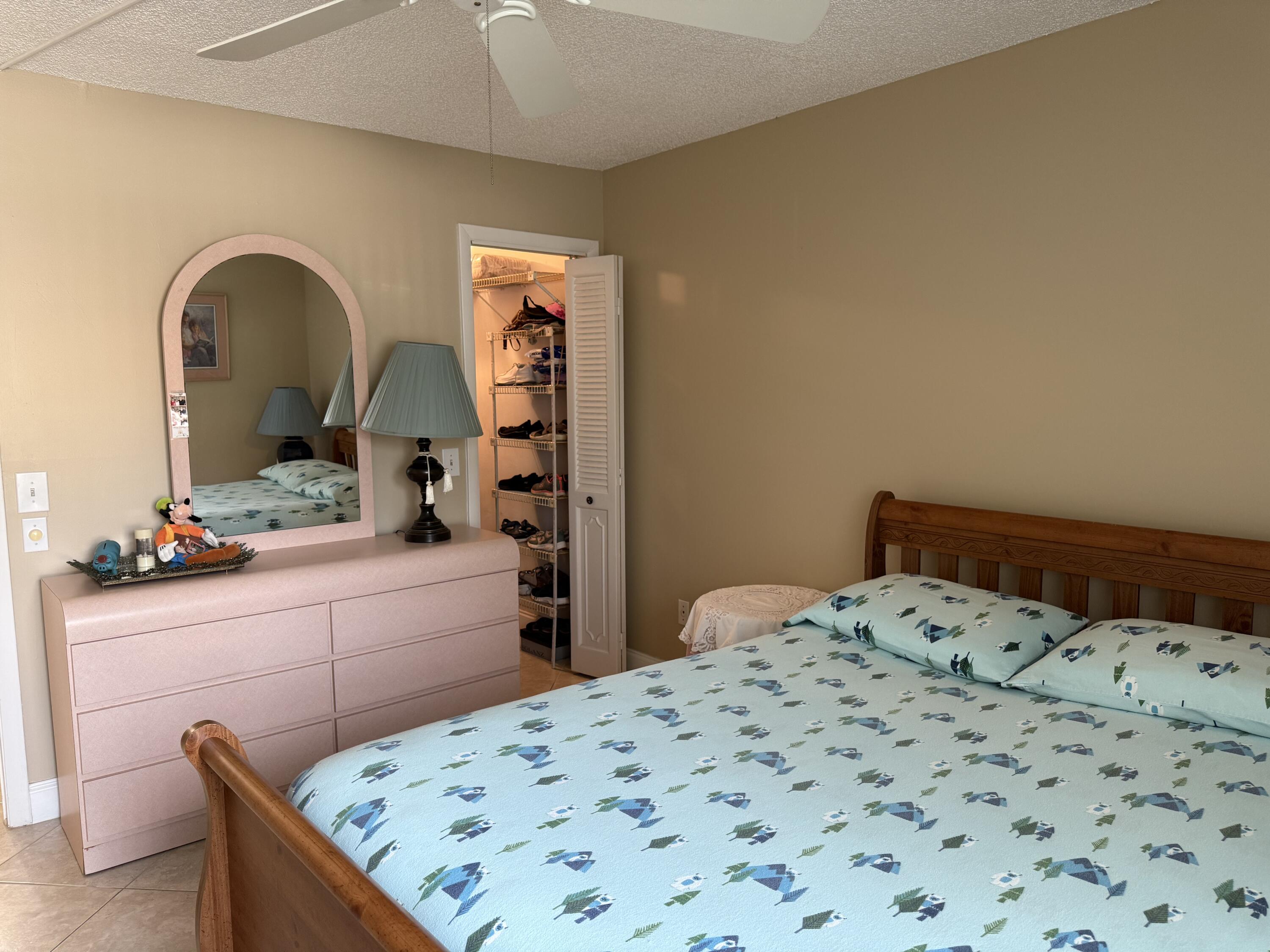 147 Burgandy Way Delray Beach, FL 33484 - Photo 10 of 14 a bedroom with a bed and a dresser