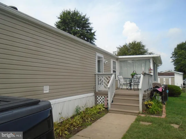 a view of a house with wooden deck and furniture
