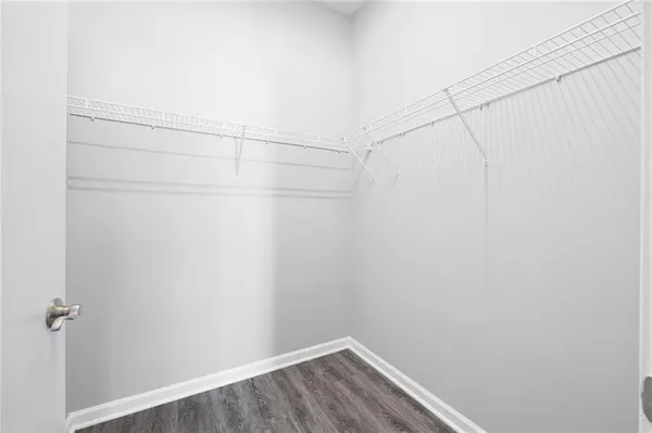a view of a room with wooden floor