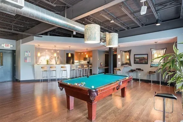 a room with lots of furniture wooden floor and sofas