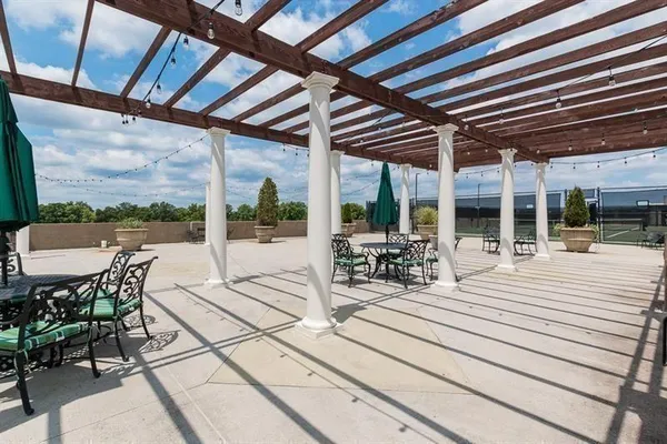 a view of a patio with a dining table and chairs