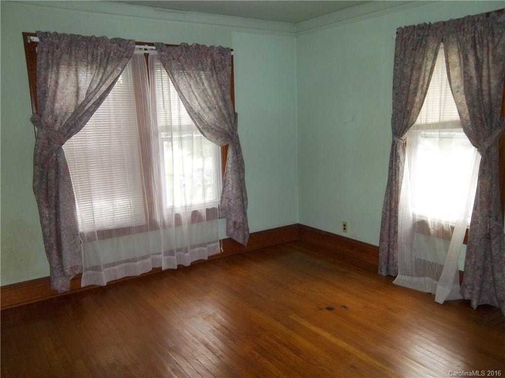 635 Allen Farm Road Canton, NC 28716 - Photo 6 of 11 an empty room with wooden floor and windows
