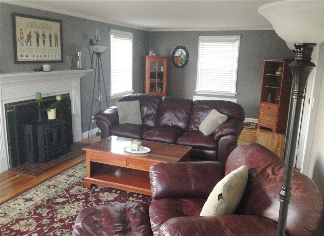 41 Fairfield Road Cranston, RI 02910 - Photo 7 of 9 back half of living room note wood stove in fireplace