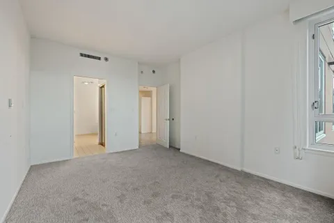a view of an empty room and a window