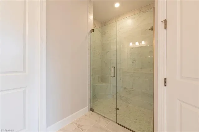 a bathroom with a glass shower door