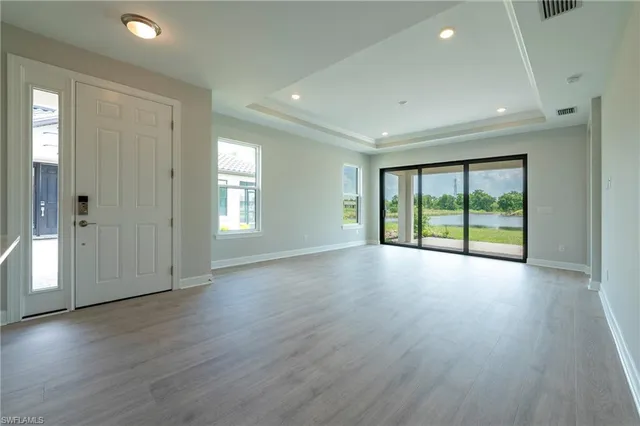 a view of a livingroom with wooden floor and window
