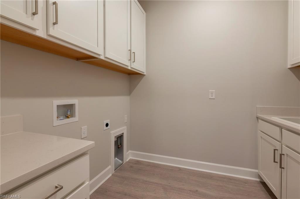 15633 Gavello Street Naples, FL 34114 - Photo 22 of 37 a view of cabinets and wooden floor