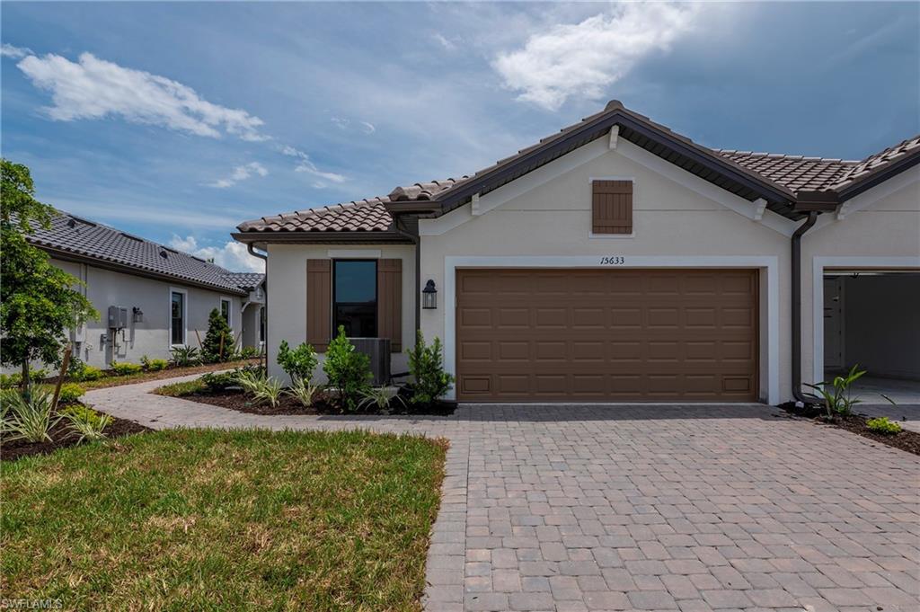 15633 Gavello Street Naples, FL 34114 - Photo 24 of 37 a front view of house with yard and green space