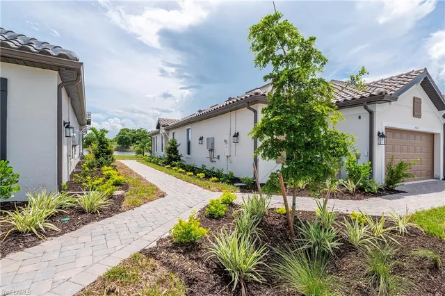 a vase of flowers sitting in a yard