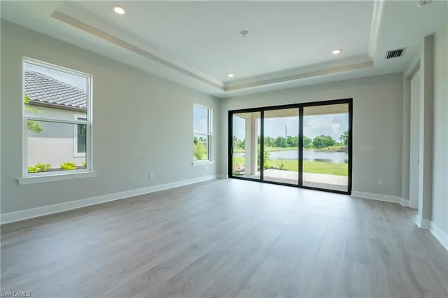 a view of an empty room with glass door and a window