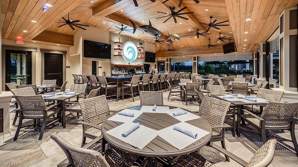 15633 Gavello Street Naples, FL 34114 - Photo 32 of 37 a view of a patio with table and chairs