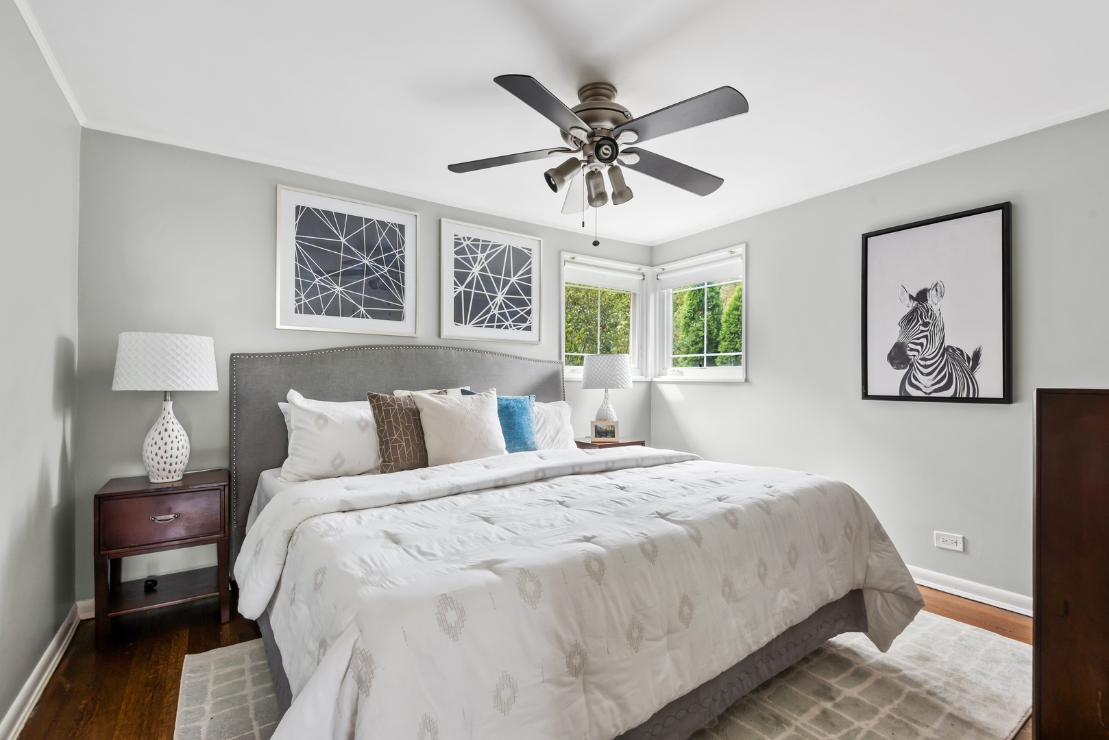 2040 Central Avenue Wilmette, IL 60091 - Photo 11 of 22 a bedroom with a large bed and a chandelier