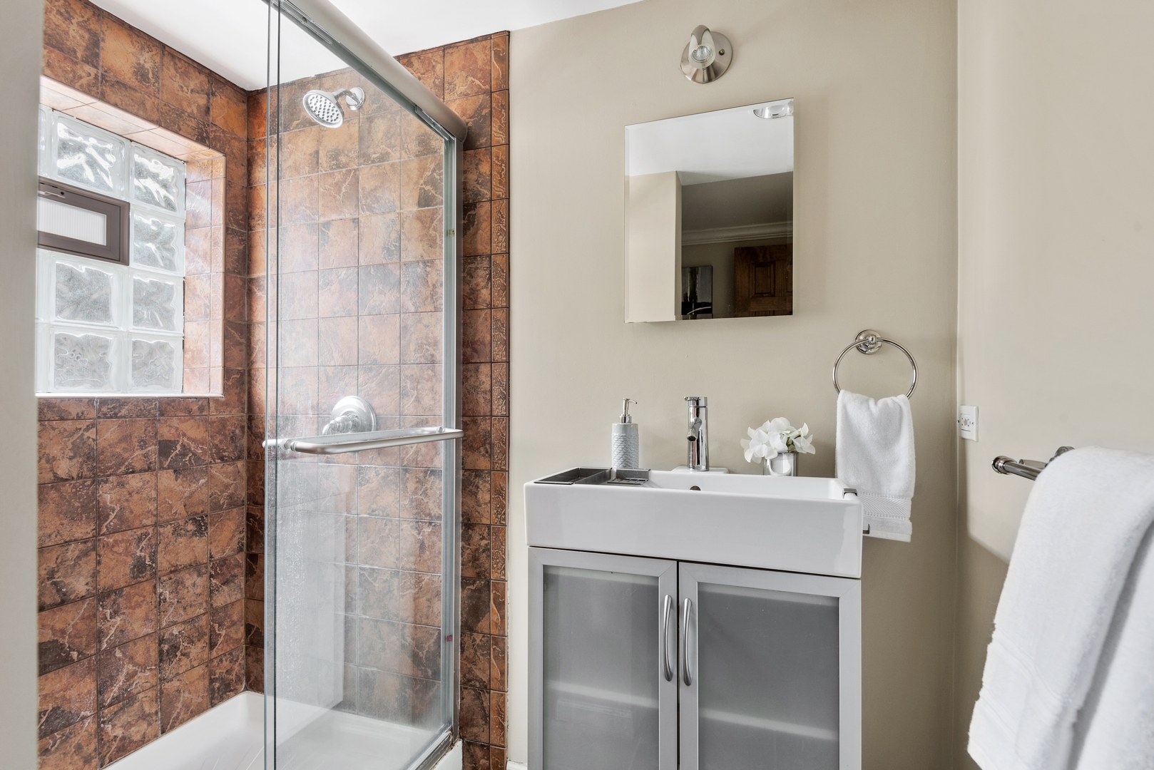 2040 Central Avenue Wilmette, IL 60091 - Photo 14 of 22 a bathroom with a sink vanity and a mirror