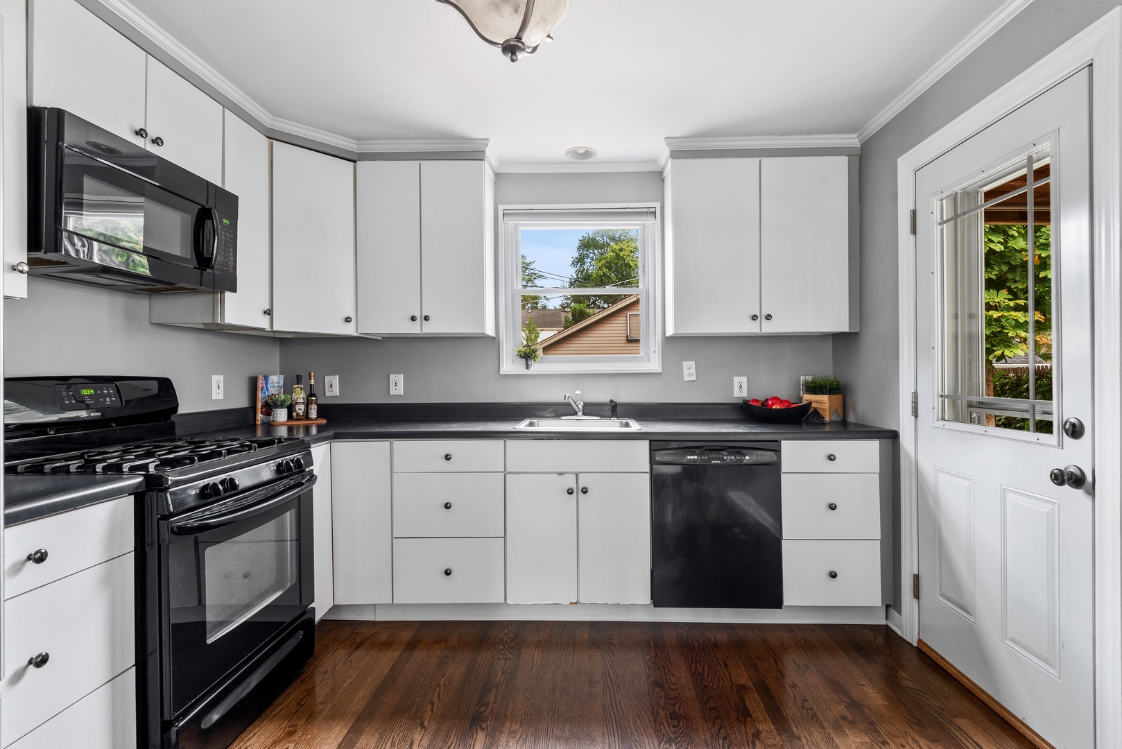 2040 Central Avenue Wilmette, IL 60091 - Photo 6 of 22 a kitchen with granite countertop white cabinets and stainless steel appliances