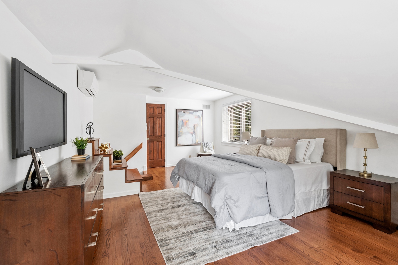 2040 Central Avenue Wilmette, IL 60091 - Photo 9 of 22 a large bedroom with a bed and wooden floor