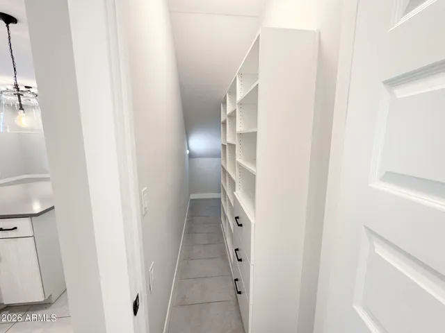 a kitchen with granite countertop white cabinets and white stove