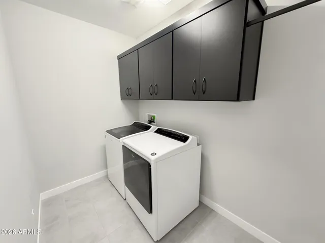 a bathroom with a double vanity sink toilet and shower