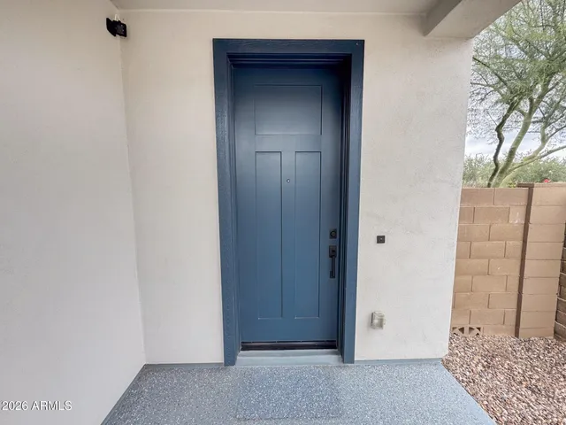 a view of a white house with a yard and plants