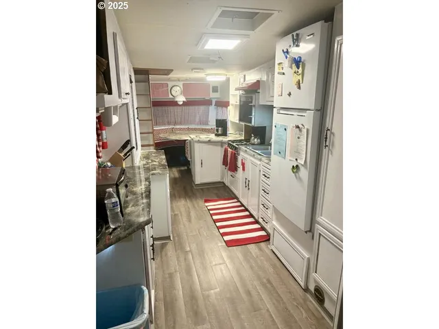a kitchen with stainless steel appliances refrigerator and cabinets