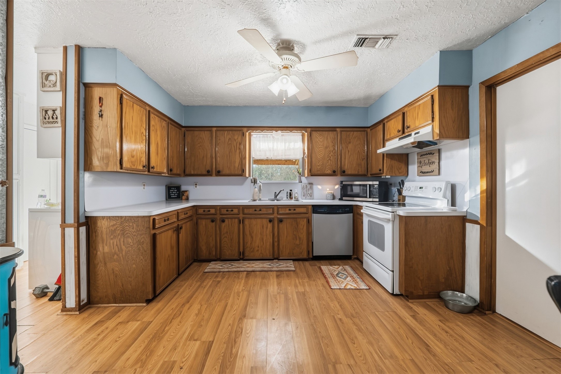 4027 Spring Branch Road Montgomery, TX 77316 - Photo 15 of 31 a kitchen with granite countertop wooden floors stainless steel appliances a sink and cabinets