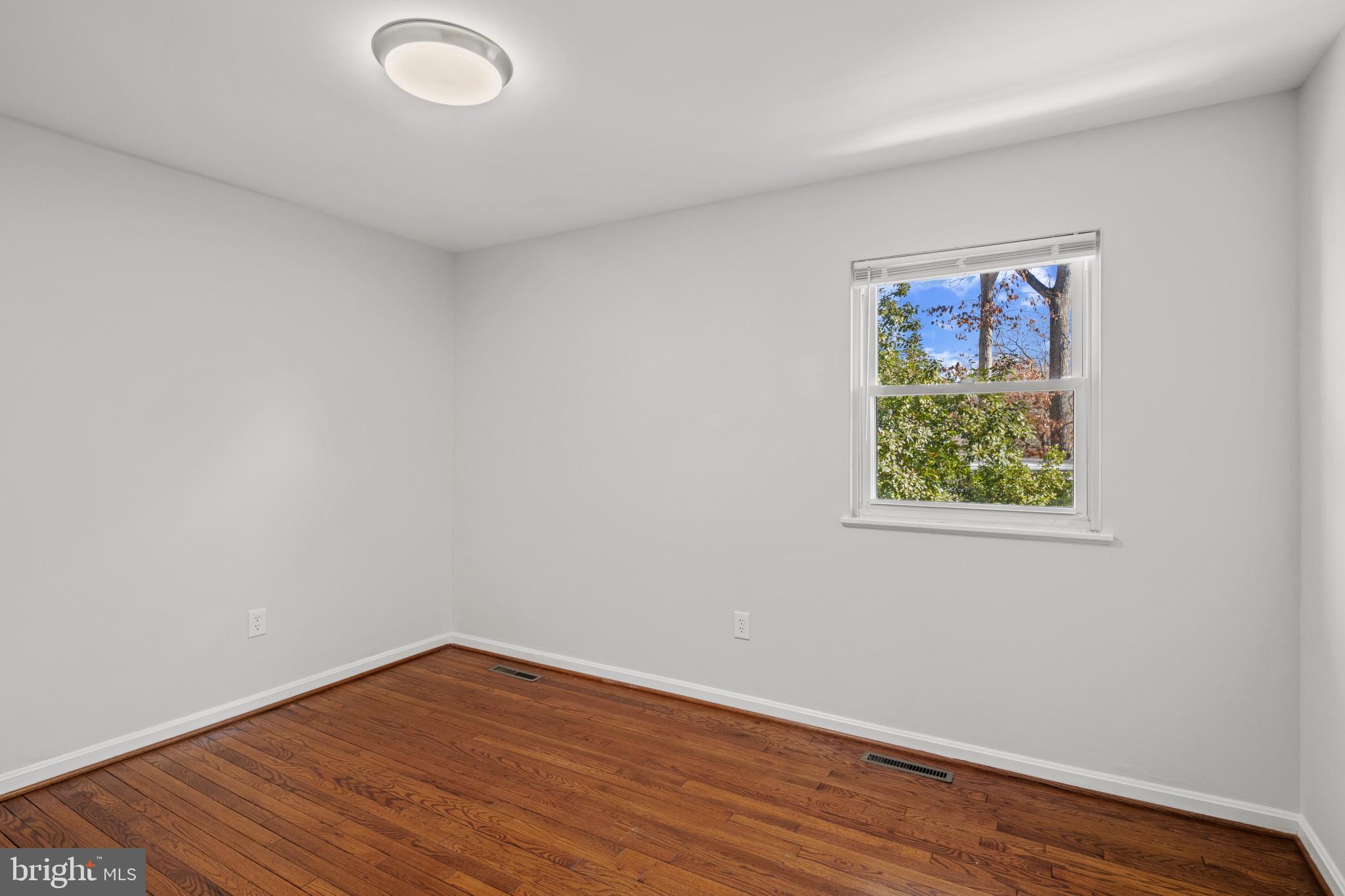 100 Oak Drive Annapolis, MD 21403 - Photo 23 of 32 a view of an empty room with wooden floor and a window