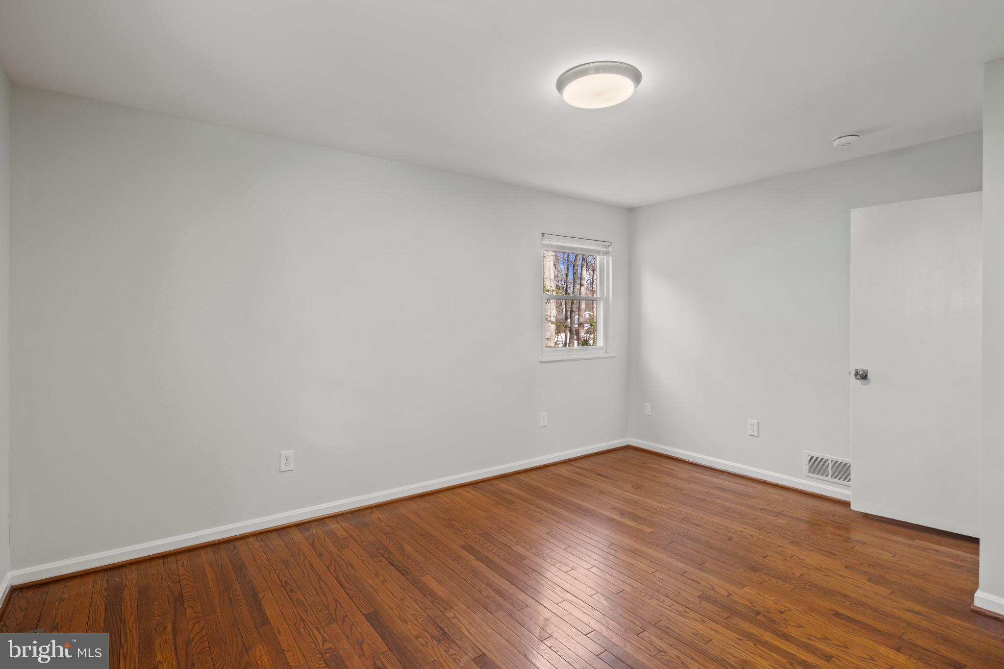 100 Oak Drive Annapolis, MD 21403 - Photo 26 of 32 an empty room with wooden floor and windows