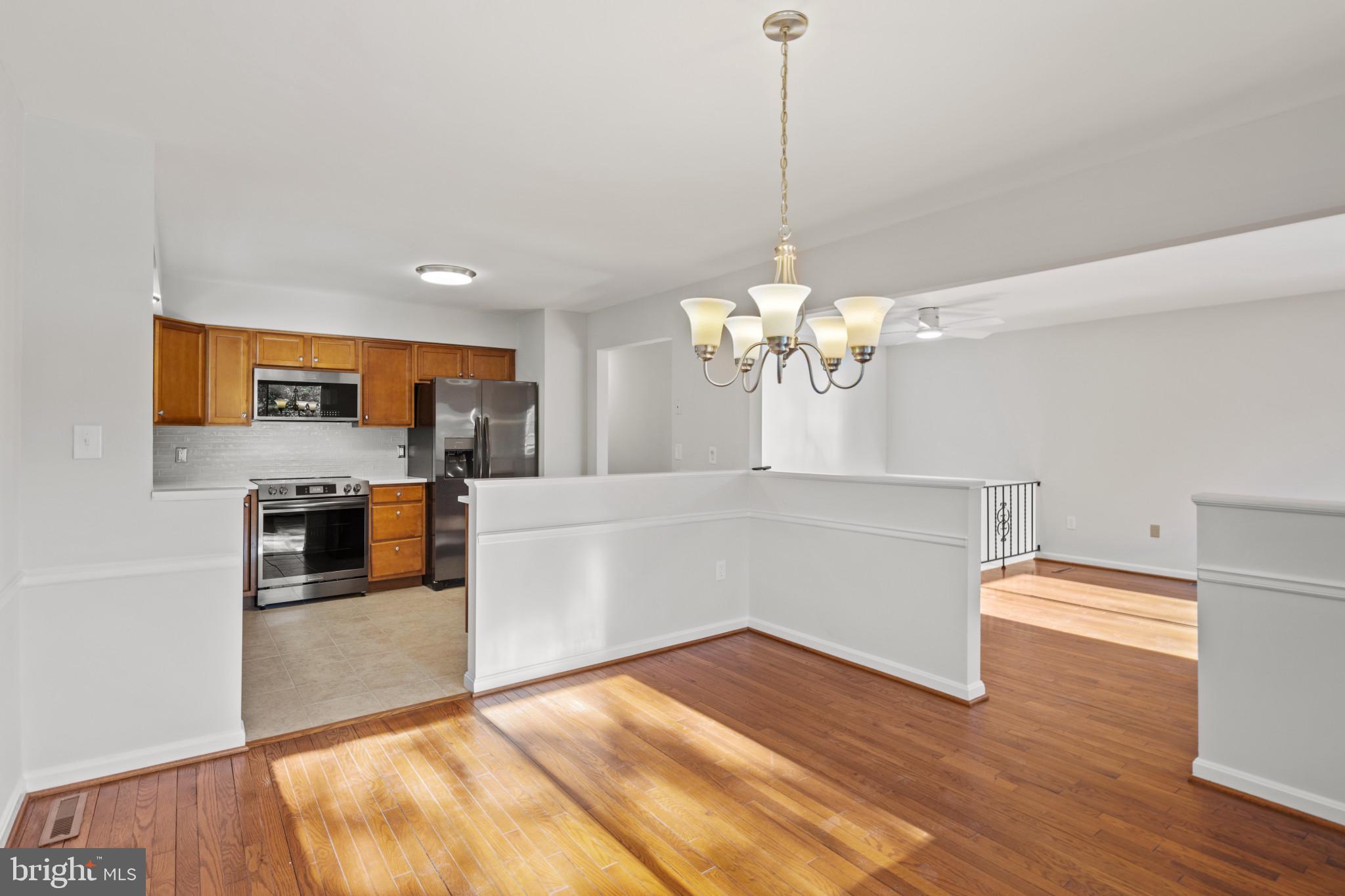 100 Oak Drive Annapolis, MD 21403 - Photo 6 of 32 a view of a kitchen with a sink and dishwasher with wooden floor