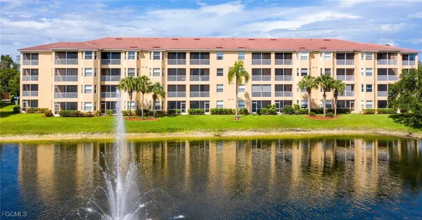 a white building with river in front of it