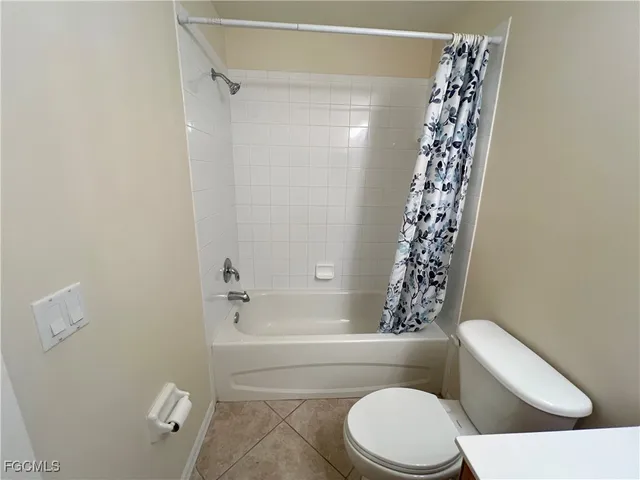 a white toilet sitting next to a bath tub