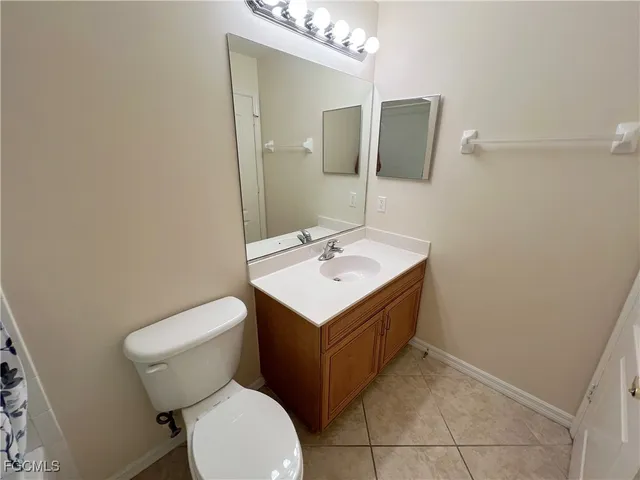 a bathroom with a sink toilet and mirror