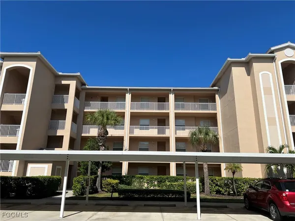 a front view of a building with a garden