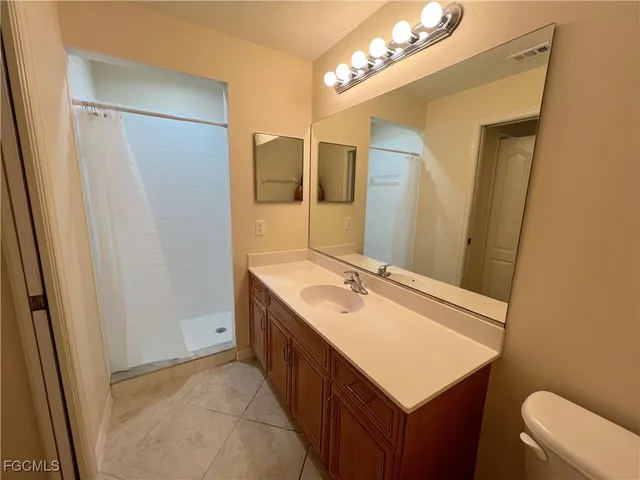 a bathroom with a sink vanity granite and a mirror