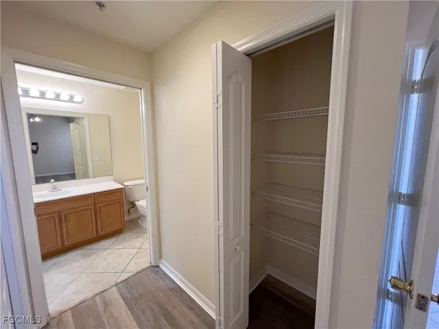 a bathroom with a tub shower and sink