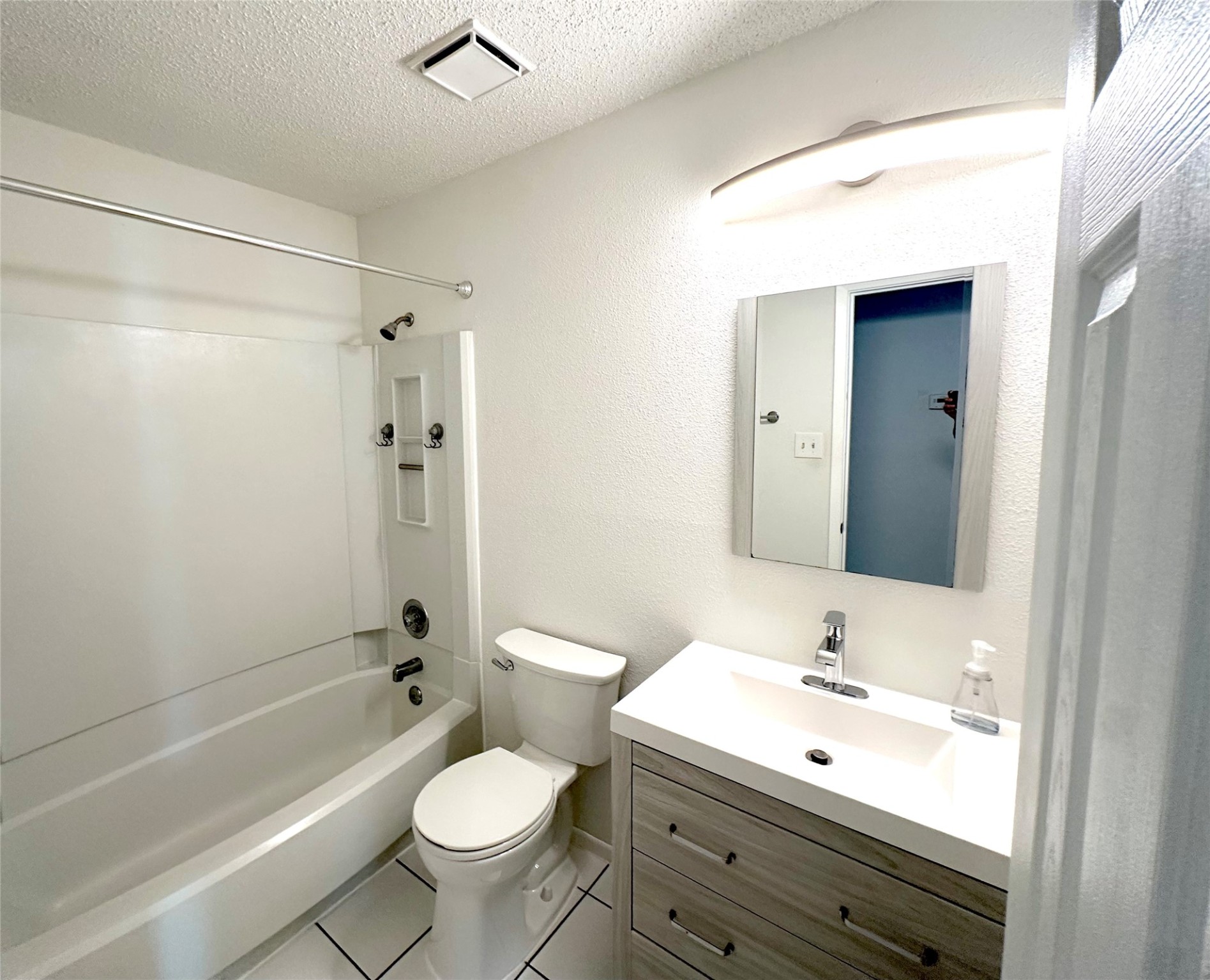 3103 Cliff Swallow Court Spring, TX 77373 - Photo 14 of 33 Secondary bathroom has been updated with vanity, lighting, toilet, and tile flooring.