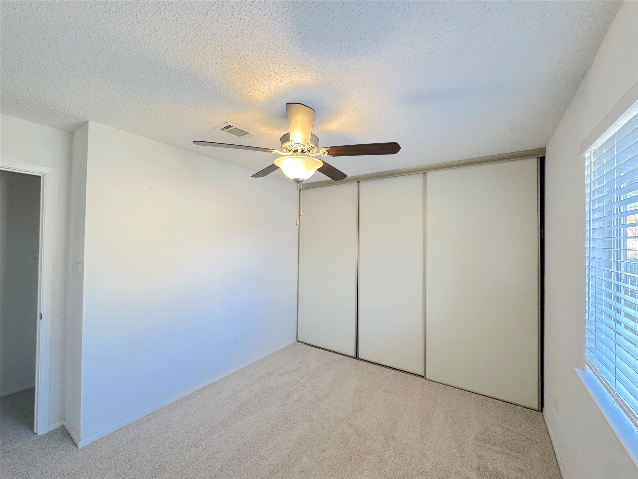 3103 Cliff Swallow Court Spring, TX 77373 - Photo 24 of 33 Secondary bedroom has ceiling fan and wall of closets!